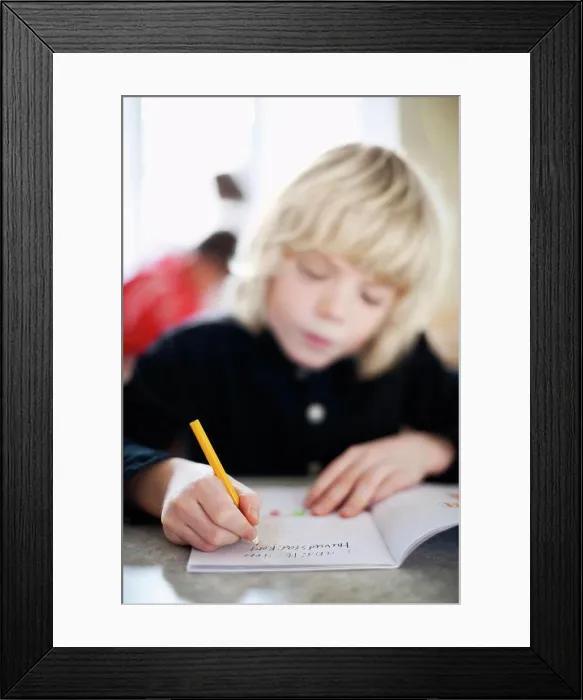 Framed Print : Close-up on boy's writing in book Framed Print : Close-up on boy's writing in book