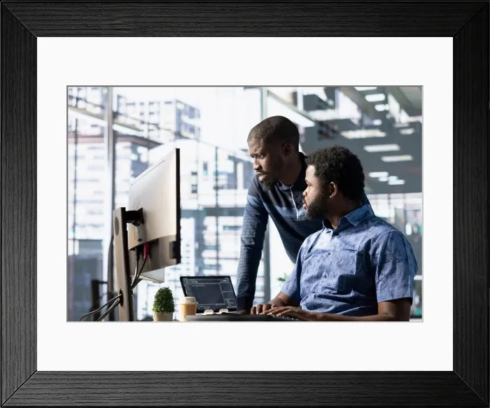 Framed Print : Data engineering IT staff members at PC desk developing machine learning algorithms Framed Print : Data engineering IT staff members at PC desk developing machine learning algorithms