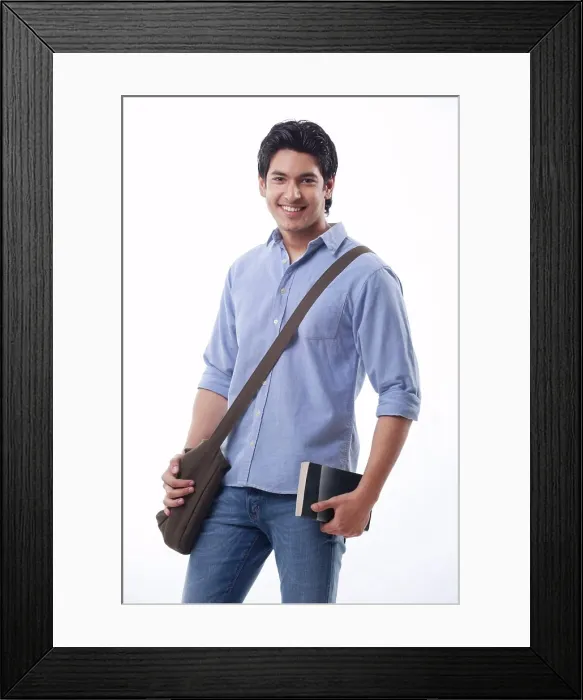 Framed Print : Young man holding book and shoulder bag Framed Print : Young man holding book and shoulder bag