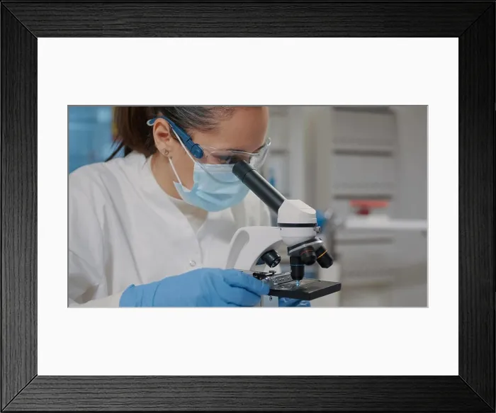 Framed Print : Biologist with face mask using microscope in science laboratory Framed Print : Biologist with face mask using microscope in science laboratory