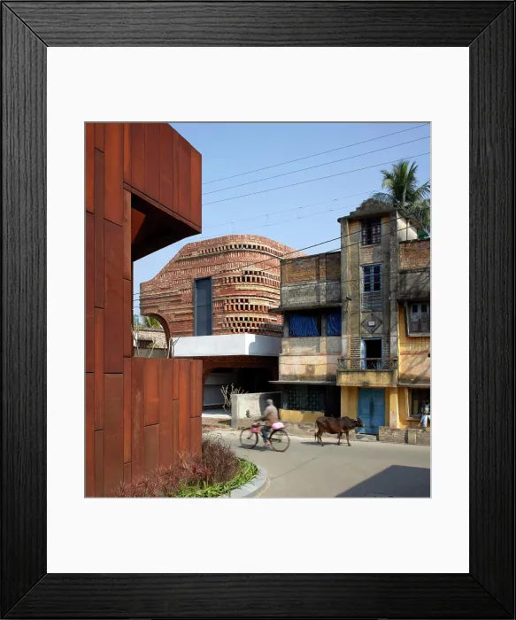 Framed Print : Street view with passing holy cow and villager on bike Framed Print : Street view with passing holy cow and villager on bike