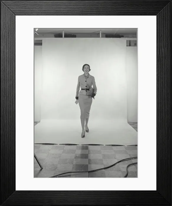 Framed Print : Vintage Photograph. Full length view of woman wearing light grey skirt and jacket and hat on white studio background Framed Print : Vintage Photograph. Full length view of woman wearing light grey skirt and jacket and hat on white studio background