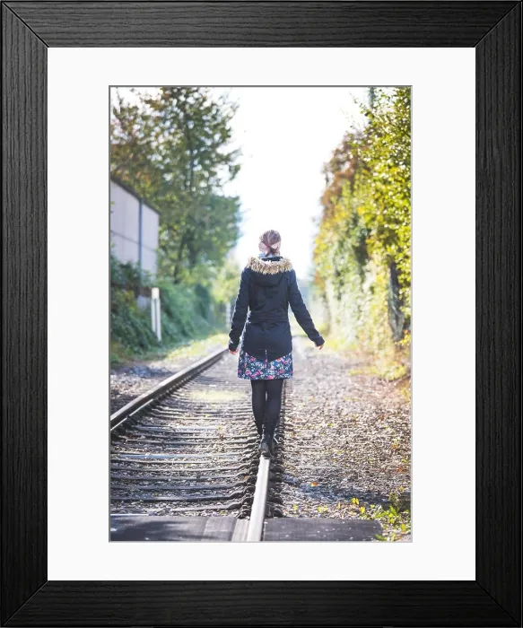Framed Print : Young pretty girl is balancing on railroad, concept for travelling Framed Print : Young pretty girl is balancing on railroad, concept for travelling