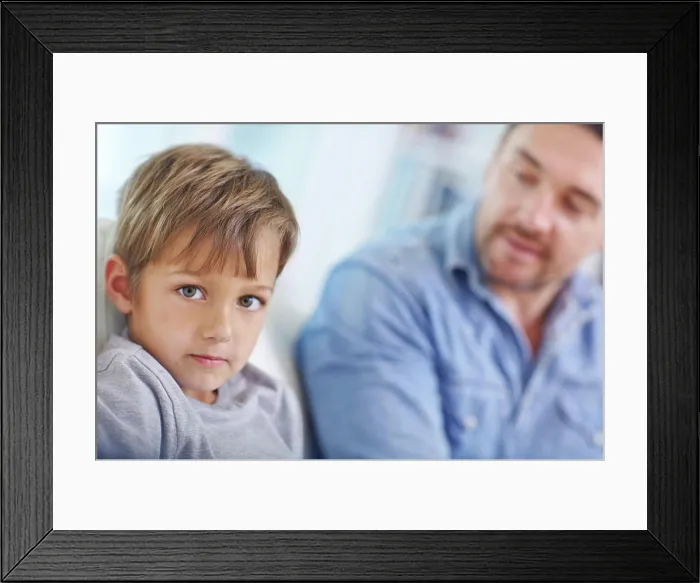 Framed Print : Discipline, naughty and portrait of boy with dad on sofa in living room of home for correction or lesson Framed Print : Discipline, naughty and portrait of boy with dad on sofa in living room of home for correction or lesson
