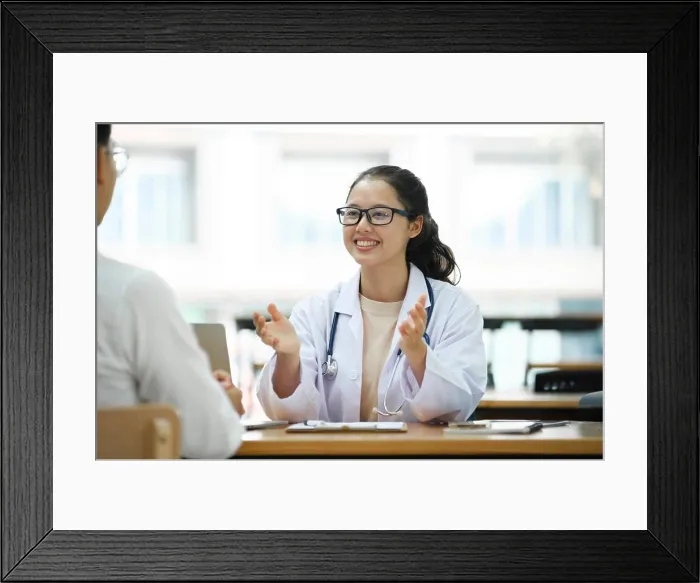 Framed Print : Doctor talking to a patient at medical clinic Framed Print : Doctor talking to a patient at medical clinic
