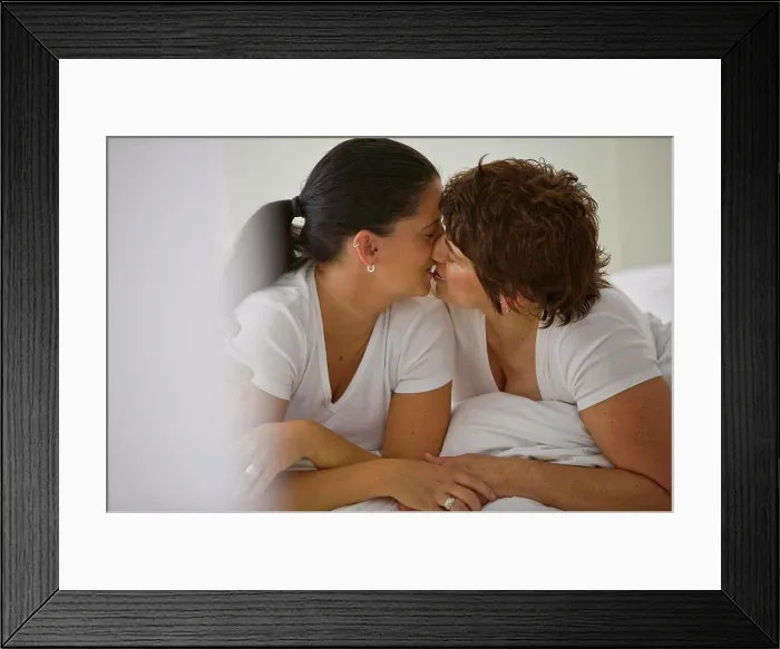 Framed Print : Two women kissing on a bed Framed Print : Two women kissing on a bed