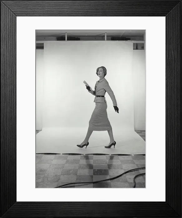Framed Print : Vintage Photograph. Full length view of woman wearing light grey skirt and jacket and hat on white studio background Framed Print : Vintage Photograph. Full length view of woman wearing light grey skirt and jacket and hat on white studio background