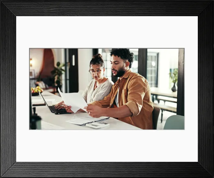 Framed Print : Paperwork, laptop or couple for budget goal Framed Print : Paperwork, laptop or couple for budget goal