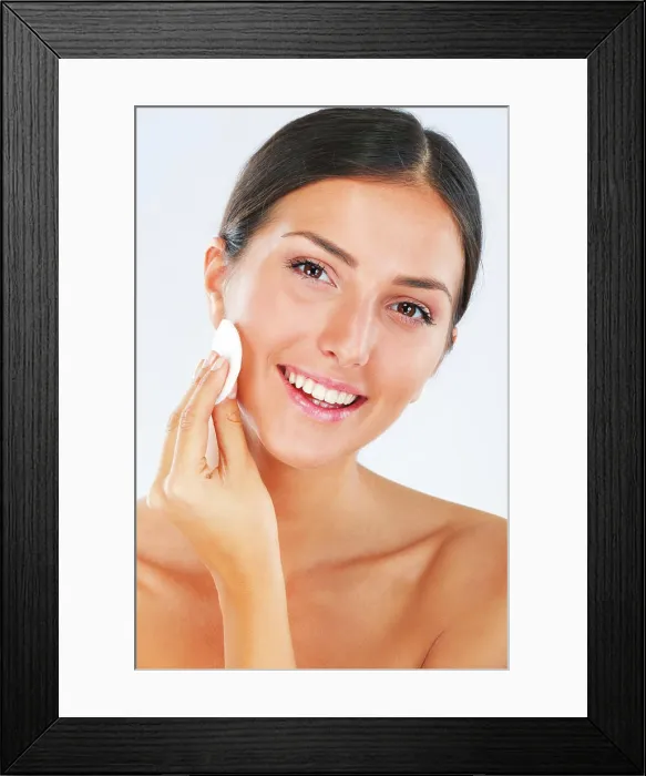 Framed Print : Portrait of a woman with a cotton pad for skincare in studio for a beauty Framed Print : Portrait of a woman with a cotton pad for skincare in studio for a beauty