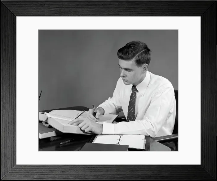Framed Print : 1950S Young Man Sitting At Desk Studying