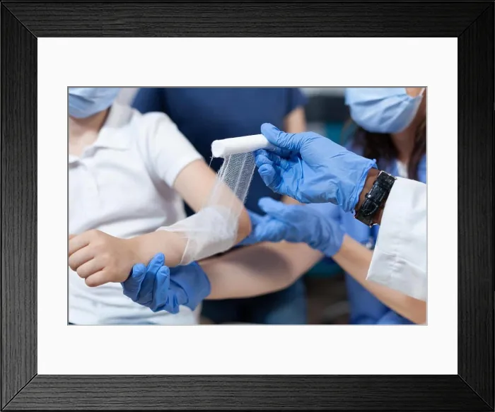 Framed Print : Closeup of african american pediatrician doctor bandage fractured injured arm