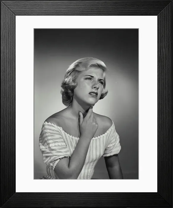 Framed Print : Vintage Photograph. Young blonde woman wearing striped blouse holding throat in discomfort