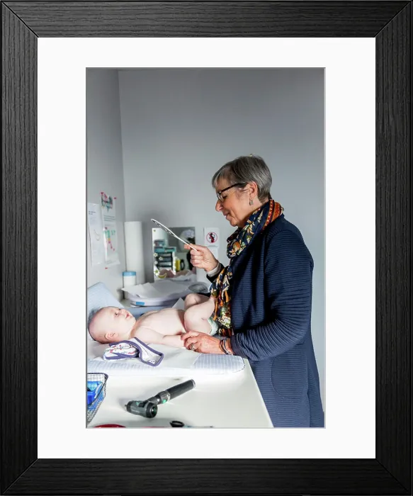Framed Print : General practitioner with baby, Geveze, France