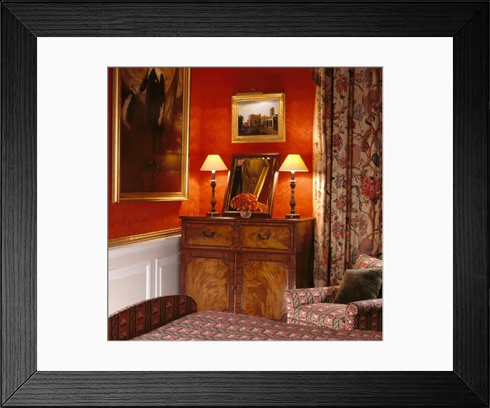 Framed Print : Lighted lamps on antique cupboard in red bedroom with patterned curtain Framed Print : Lighted lamps on antique cupboard in red bedroom with patterned curtain