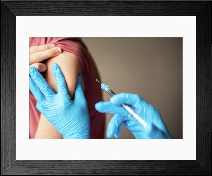 Framed Print : Close up of arm of boy getting vaccinated by doctor holding a needle Framed Print : Close up of arm of boy getting vaccinated by doctor holding a needle