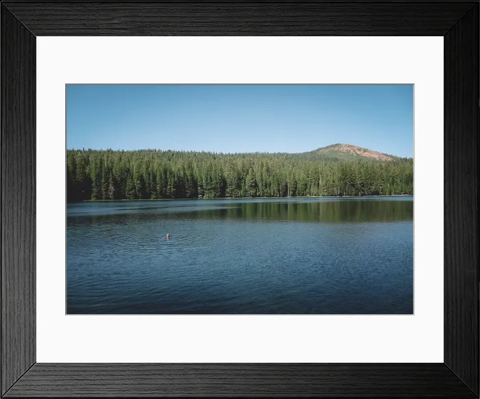 Framed Print : Distant View of Boy Treading Water in the Center of a Scenic Lake Framed Print : Distant View of Boy Treading Water in the Center of a Scenic Lake