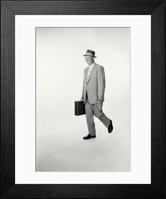Framed Print : Vintage Photograph. A studio shot of a man wearing a suit and holding a briefcase walking across frame. Frame 2 Framed Print : Vintage Photograph. A studio shot of a man wearing a suit and holding a briefcase walking across frame. Frame 2