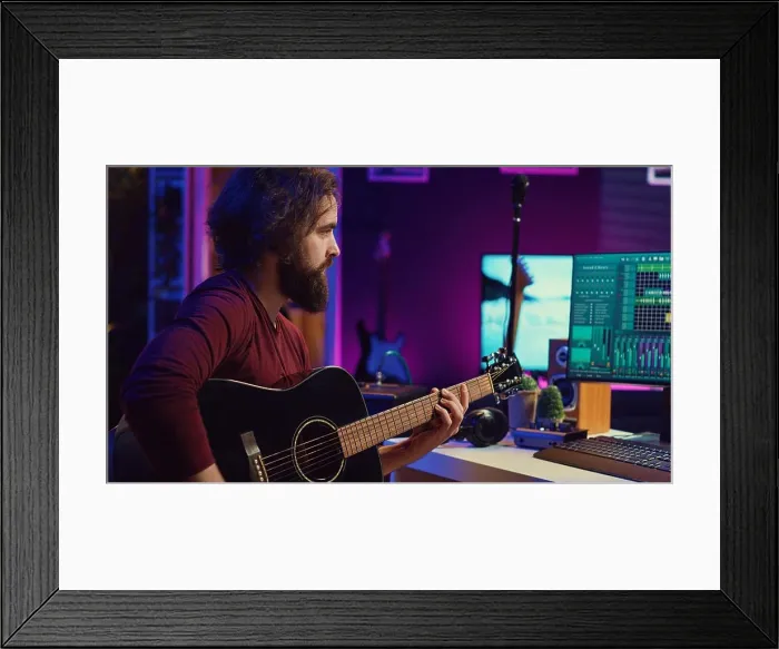 Framed Print : Musical performer recording guitar sounds for a new track in home studio Framed Print : Musical performer recording guitar sounds for a new track in home studio