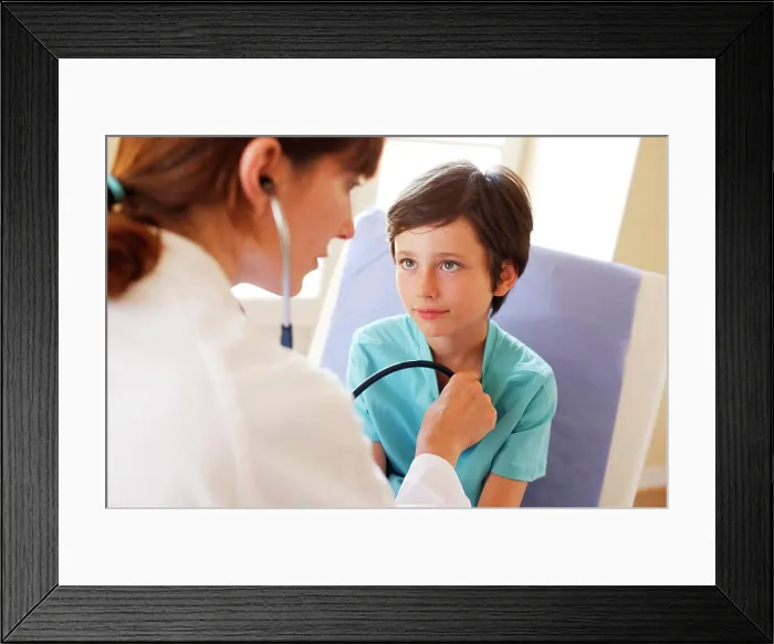 Framed Print : Doctor examining a 9 years old boy with a stethoscope Framed Print : Doctor examining a 9 years old boy with a stethoscope