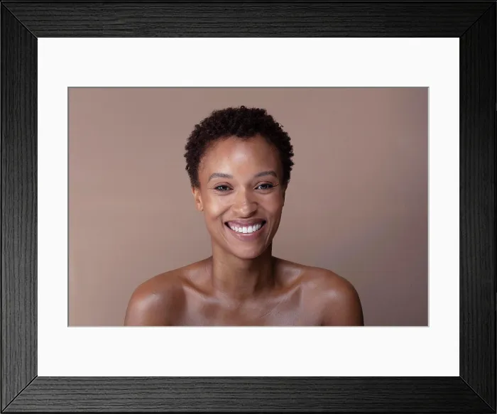 Framed Print : Studio portrait of smiling shirtless woman Framed Print : Studio portrait of smiling shirtless woman