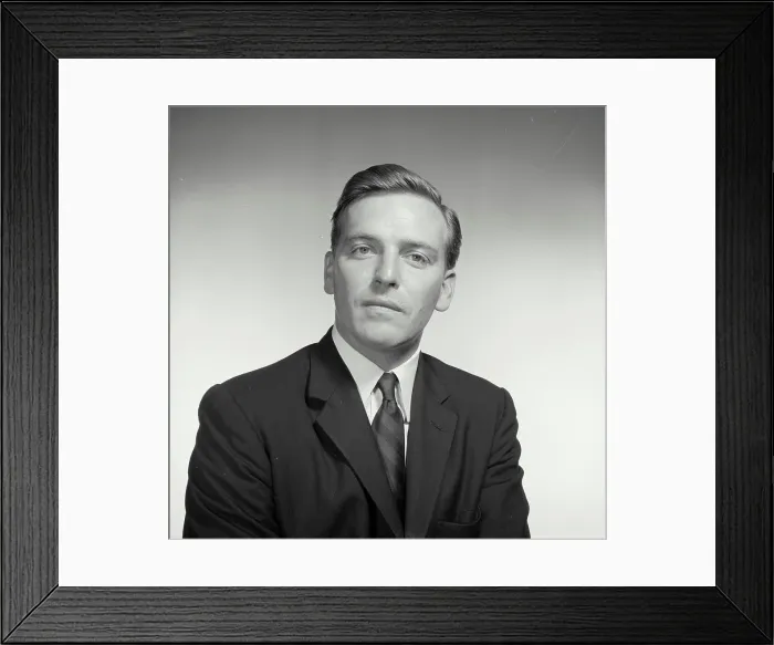 Framed Print : Vintage Photograph. With a blank stare a man sits for a studio portrait Framed Print : Vintage Photograph. With a blank stare a man sits for a studio portrait