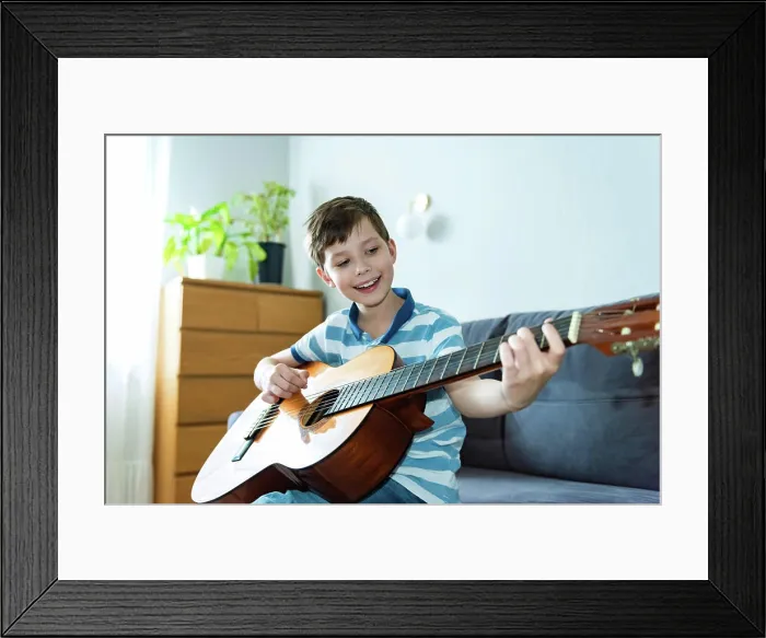 Framed Print : Portrait of teenager boy sitting on the cozy sofa Framed Print : Portrait of teenager boy sitting on the cozy sofa