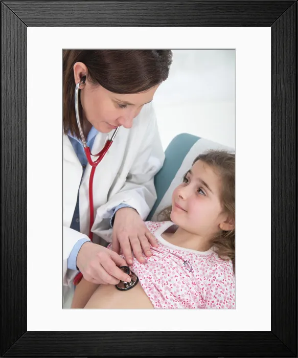 Framed Print : Doctor auscultating a girl