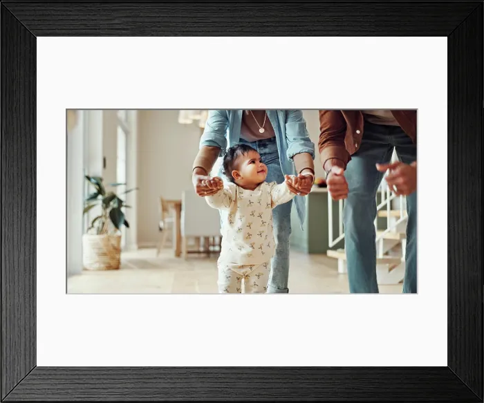 Framed Print : First steps, milestone or walking with parents and toddler in home for development or growth Framed Print : First steps, milestone or walking with parents and toddler in home for development or growth