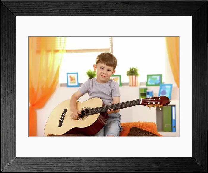 Framed Print : Cute small kid with guitar Cute small kid having fun with guitar at home Framed Print : Cute small kid with guitar Cute small kid having fun with guitar at home