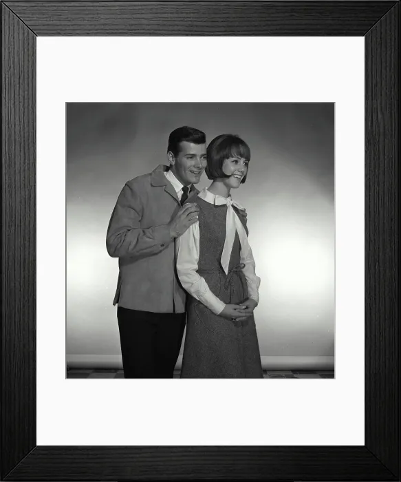 Framed Print : Vintage Photograph. A man hugging woman on the shoulders while they both look to the right of frame