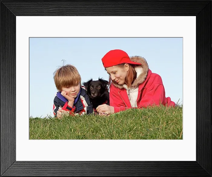 Framed Print : Boy and girl with a dog