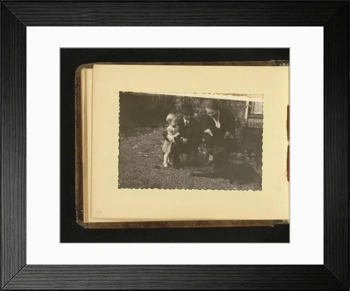 Framed Print : Child with dog, Anonymous, 1938 photograph Album magazine with a photo of a child with a dog and two adults Framed Print : Child with dog, Anonymous, 1938 photograph Album magazine with a photo of a child with a dog and two adults