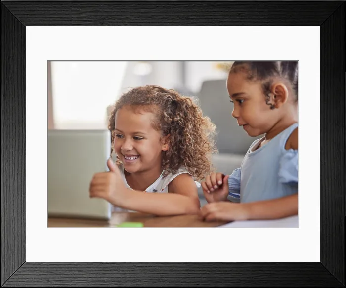 Framed Print : Happy children with digital tablet watch education or funny cartoon videos or games on the home sofa Framed Print : Happy children with digital tablet watch education or funny cartoon videos or games on the home sofa