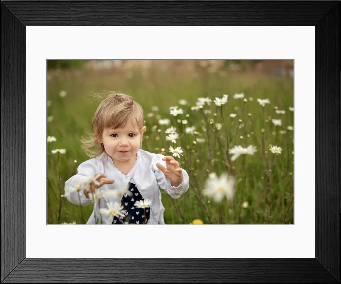 Framed Print : A young girl running to the camera through the daisy field Framed Print : A young girl running to the camera through the daisy field