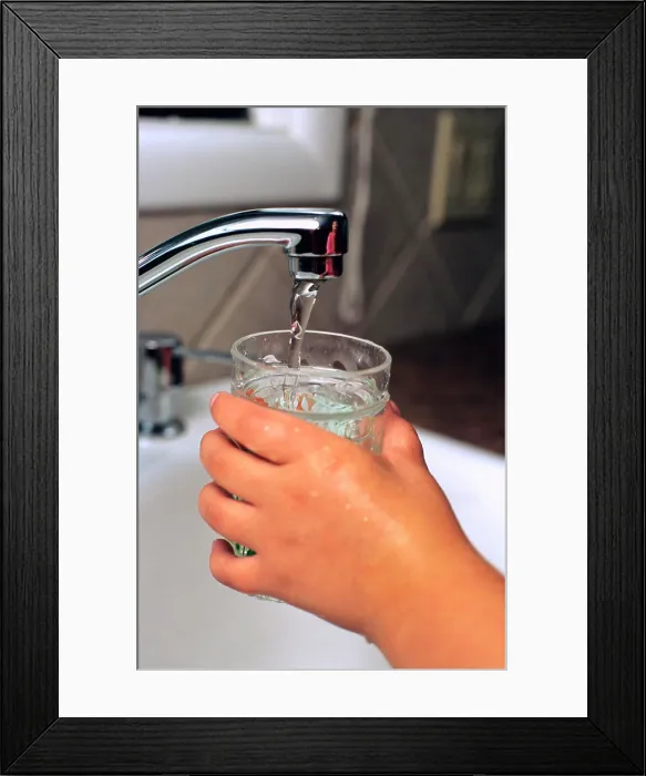 Framed Print : A child getting a glass of water from the kitchen faucet Framed Print : A child getting a glass of water from the kitchen faucet