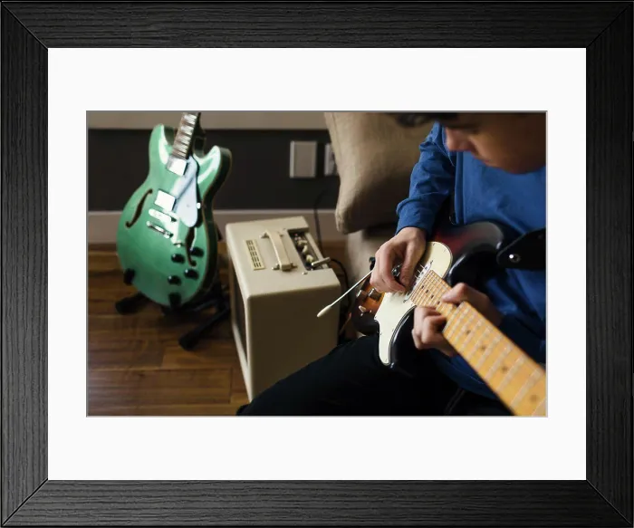 Framed Print : Close up of musician playing electric guitar