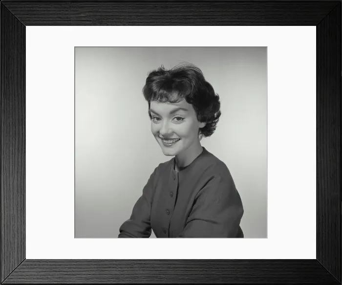 Framed Print : Vintage Photograph. Woman looks to the left while she smiles at the camera Framed Print : Vintage Photograph. Woman looks to the left while she smiles at the camera