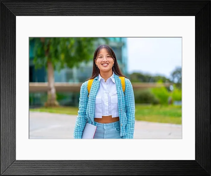 Framed Print : Portrait of a smiling chinese university student standing in the campus Framed Print : Portrait of a smiling chinese university student standing in the campus