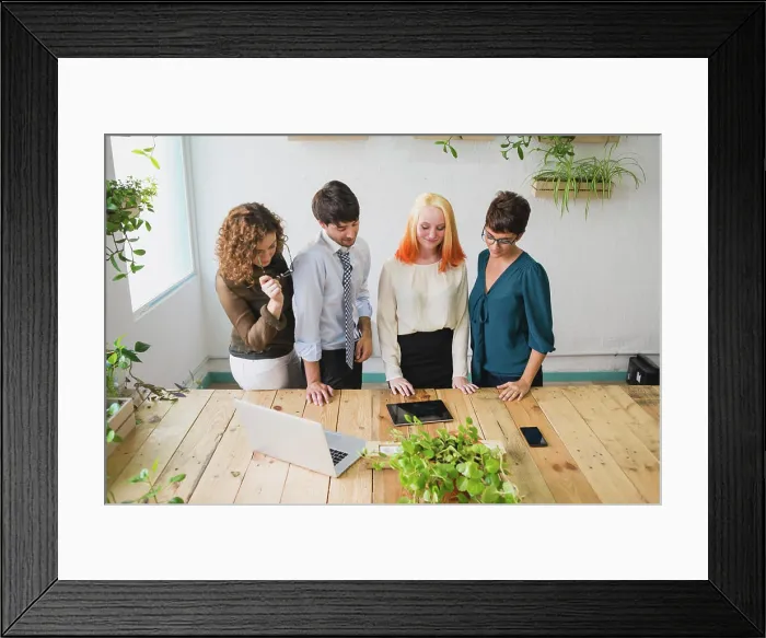 Framed Print : Four entrepreneurs looking at a tablet Framed Print : Four entrepreneurs looking at a tablet