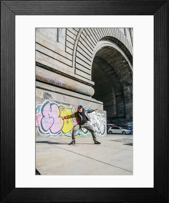Framed Print : Street dancer poses wide near colorful graffiti and stone arch Framed Print : Street dancer poses wide near colorful graffiti and stone arch