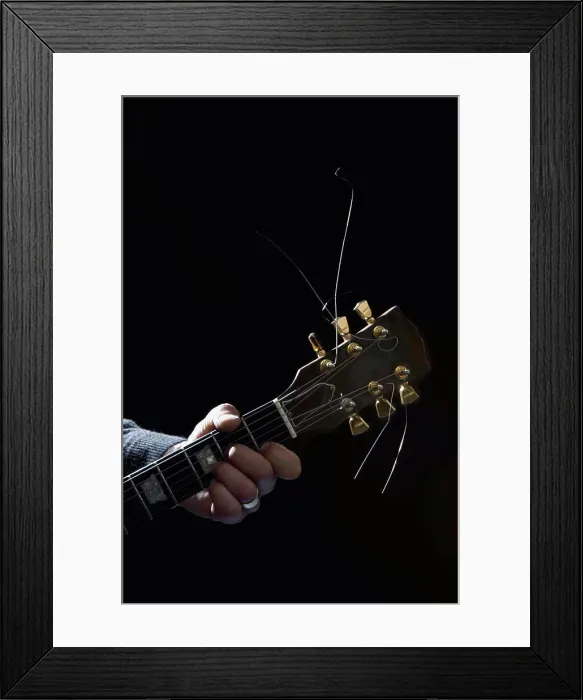 Framed Print : Detail of a man playing an electric guitar