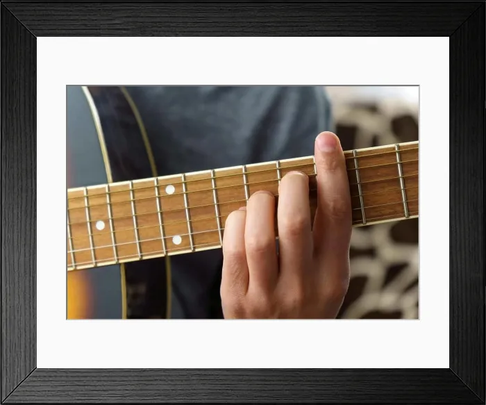 Framed Print : Guitarist male playing acoustic guitar sitting at desk Framed Print : Guitarist male playing acoustic guitar sitting at desk