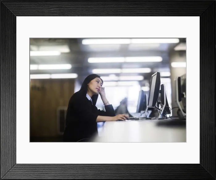 Framed Print : young asia woman with paper in an office working Framed Print : young asia woman with paper in an office working