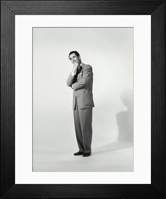 Framed Print : Man in zoot suit on white background with hand on chin