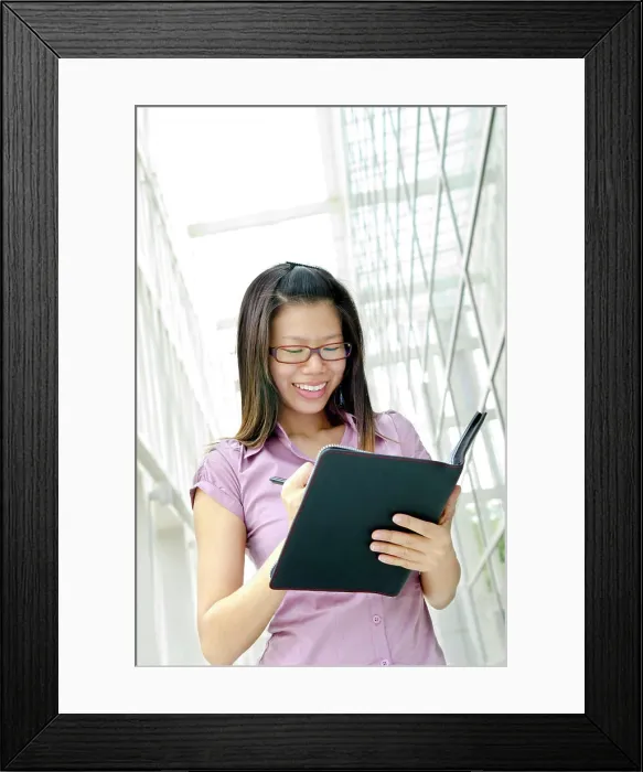 Framed Print : Young Executive Young Asian Executive writing on diary Framed Print : Young Executive Young Asian Executive writing on diary