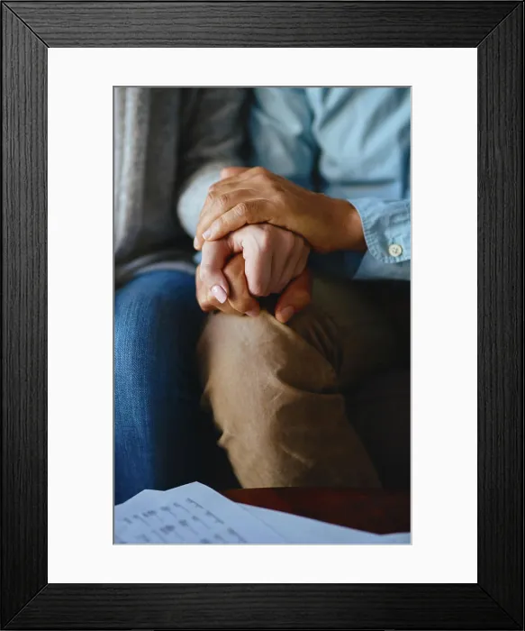 Framed Print : Holding hands, senior couple and closeup of life insurance note with paperwork in living room Framed Print : Holding hands, senior couple and closeup of life insurance note with paperwork in living room