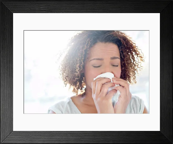 Framed Print : Woman blowing nose on tissue Framed Print : Woman blowing nose on tissue