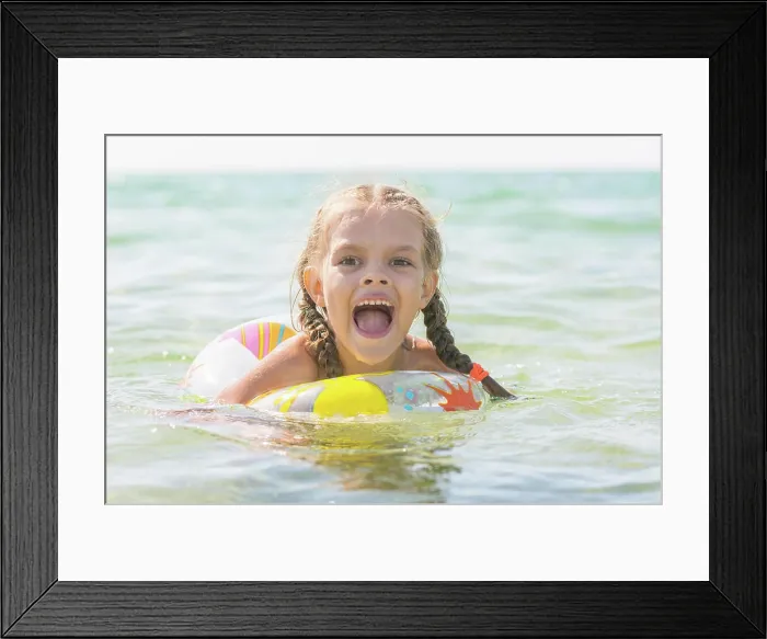 Framed Print : Six year old girl bathing in the sea with his mouth open in pleasure Six-year girl bathes with a swimming circle Framed Print : Six year old girl bathing in the sea with his mouth open in pleasure Six-year girl bathes with a swimming circle