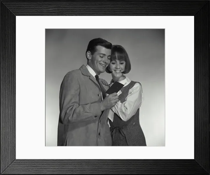 Framed Print : Vintage Photograph. A man and woman looking at bank book excitedly Framed Print : Vintage Photograph. A man and woman looking at bank book excitedly