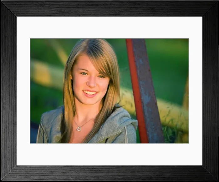 Framed Print : Young woman beside old metal structure